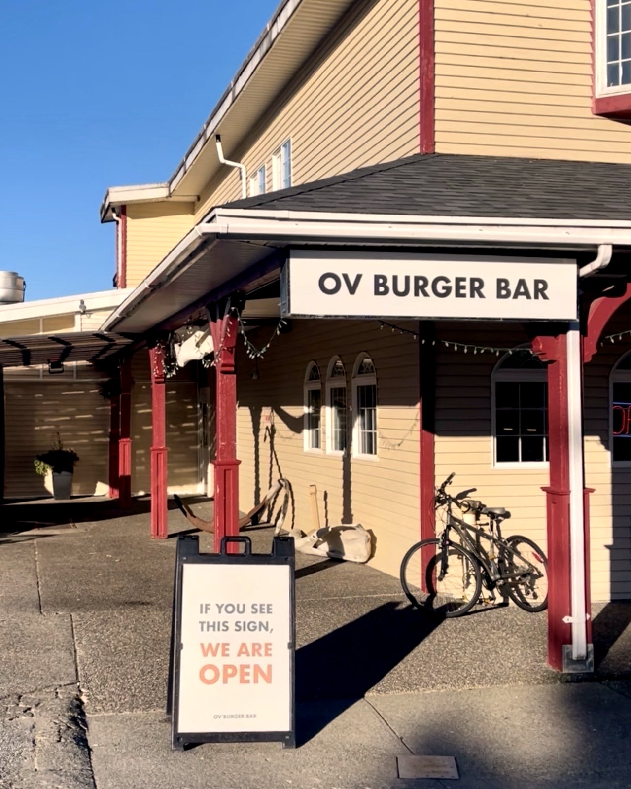 The OV Burger Bar entrance and sandwich-board sign in front of the historic Ocean View Hotel building in Prince Rupert, BC