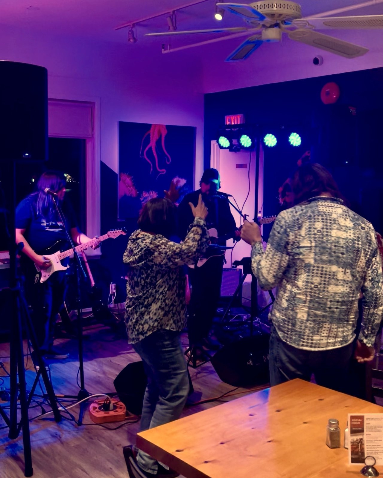 A live band performing under stage lights with guests dancing on a Friday night at OV Burger Bar in Prince Rupert, BC