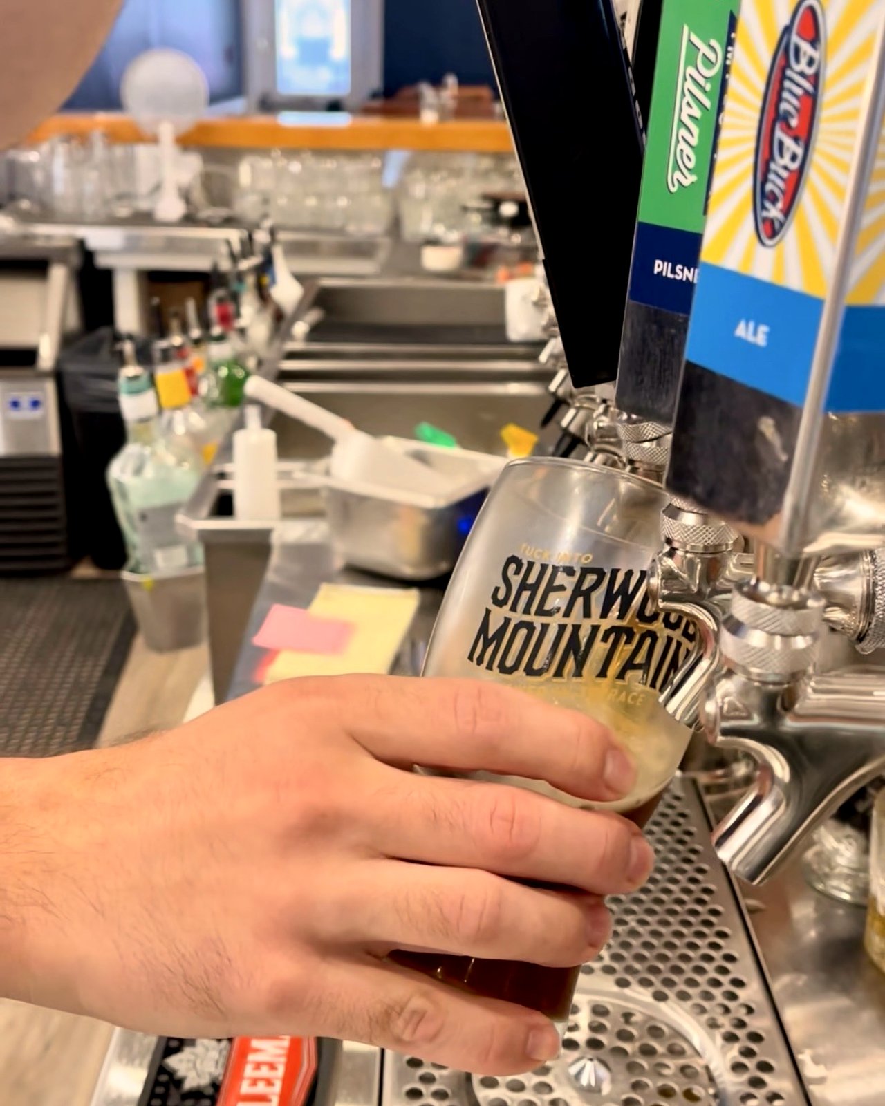 Bartender pouring a Sherwood Mountain craft beer on tap at OV Burger Bar in Prince Rupert, BC